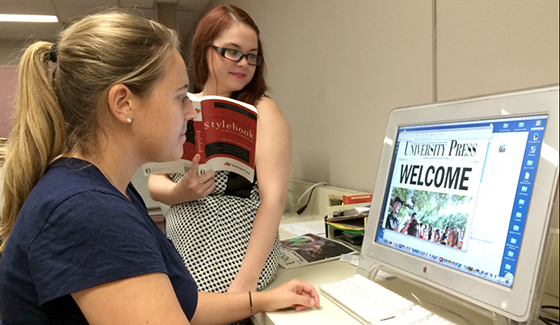 Students composing a weekly edition of the University Press newspaper.